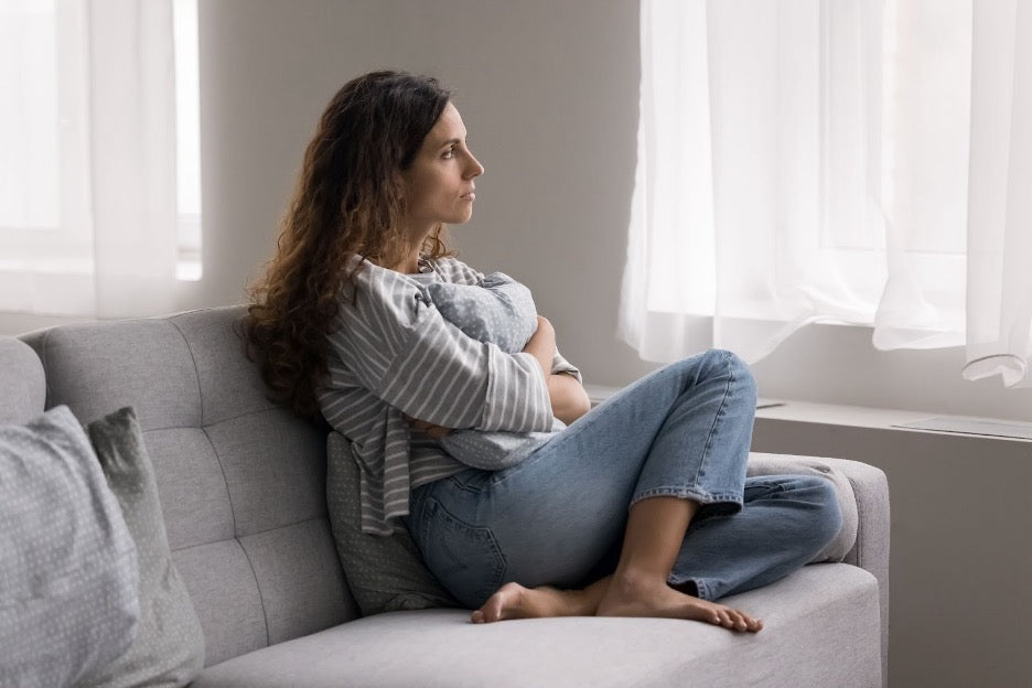 An anxious woman on a couch.