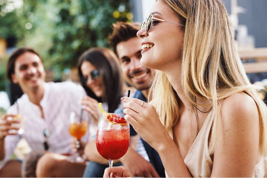 A group of friends drinking alcohol outside.
