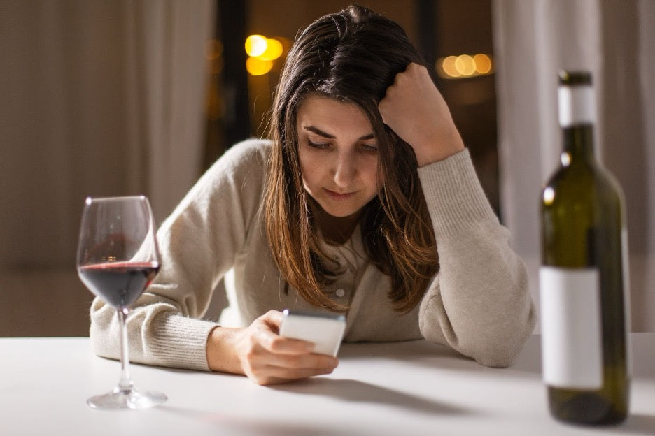 A woman drinking wine.