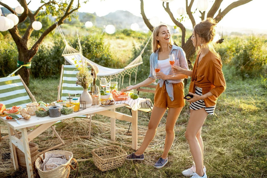 Two women at an outdoor dinner party.