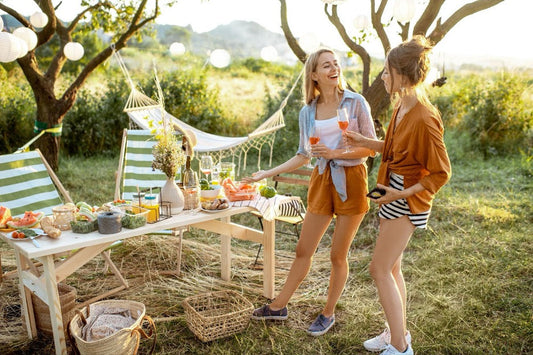 Two women at an outdoor dinner party.
